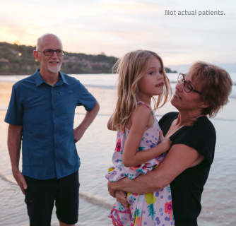 Grandfather, grandmother and granddaughter at the shore