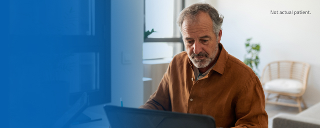 Older man at laptop in his home office