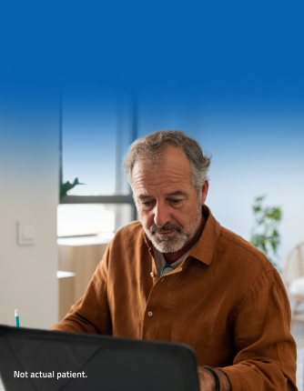 Older man at laptop in his home office